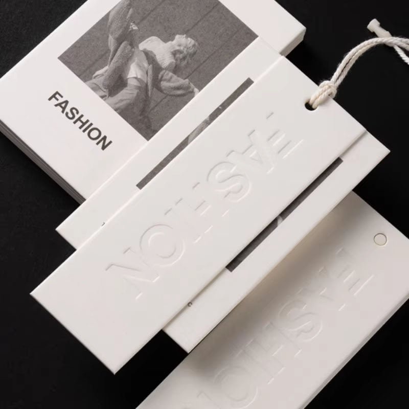 Quiet Luxury Style Clothing Hang Tags Custom Debossed Special Texture Paper Swing Tags for High-End Minimalist Garment Brands